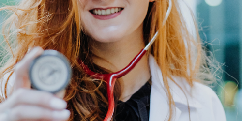 Close up of a doctor holding a stethoscope up to the camera