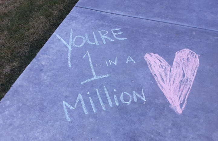 Chalk design on sidewalk that says "You're 1 in a million"