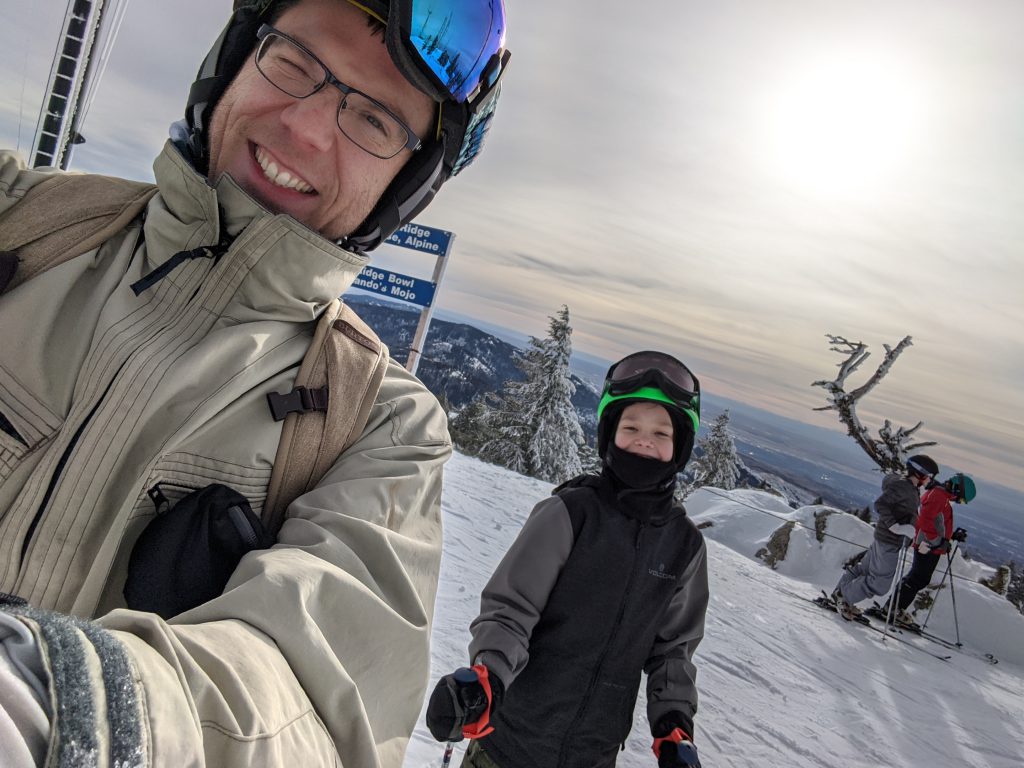 Joshua Hon skiing with his son